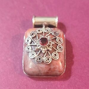 Hand-crafted sterling pendant with Rhodolite and Garnet.